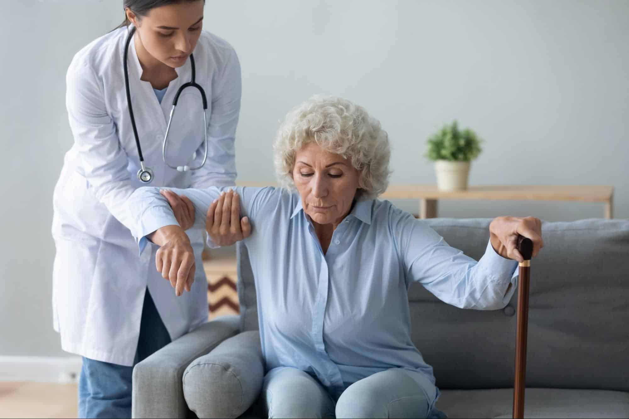 Doctor helping patient stand up