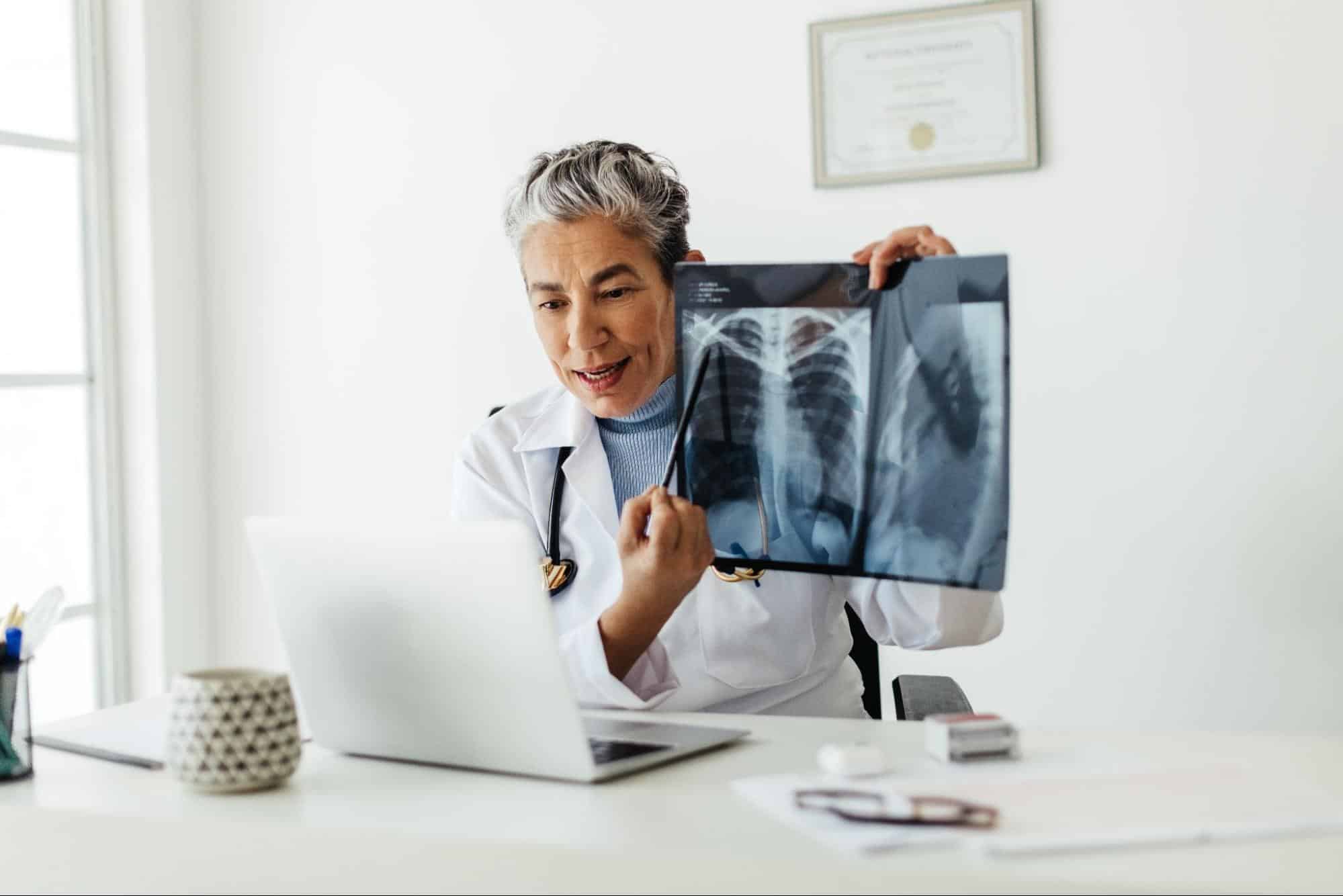 Doctor showing x-ray results to patient over Zoom