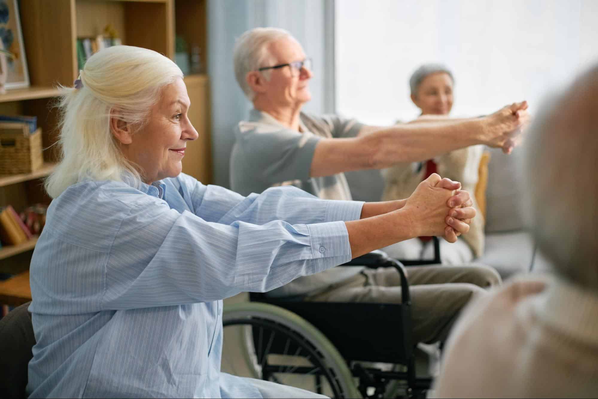 Seniors exercising while sitting down
