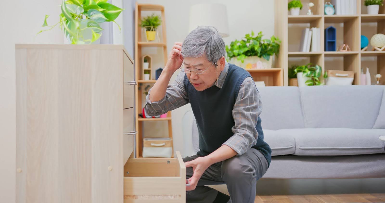 Senior opening a drawer