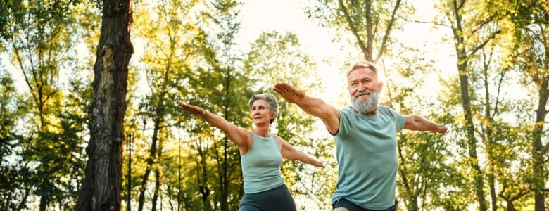 Seniors outside at a park doing yoga