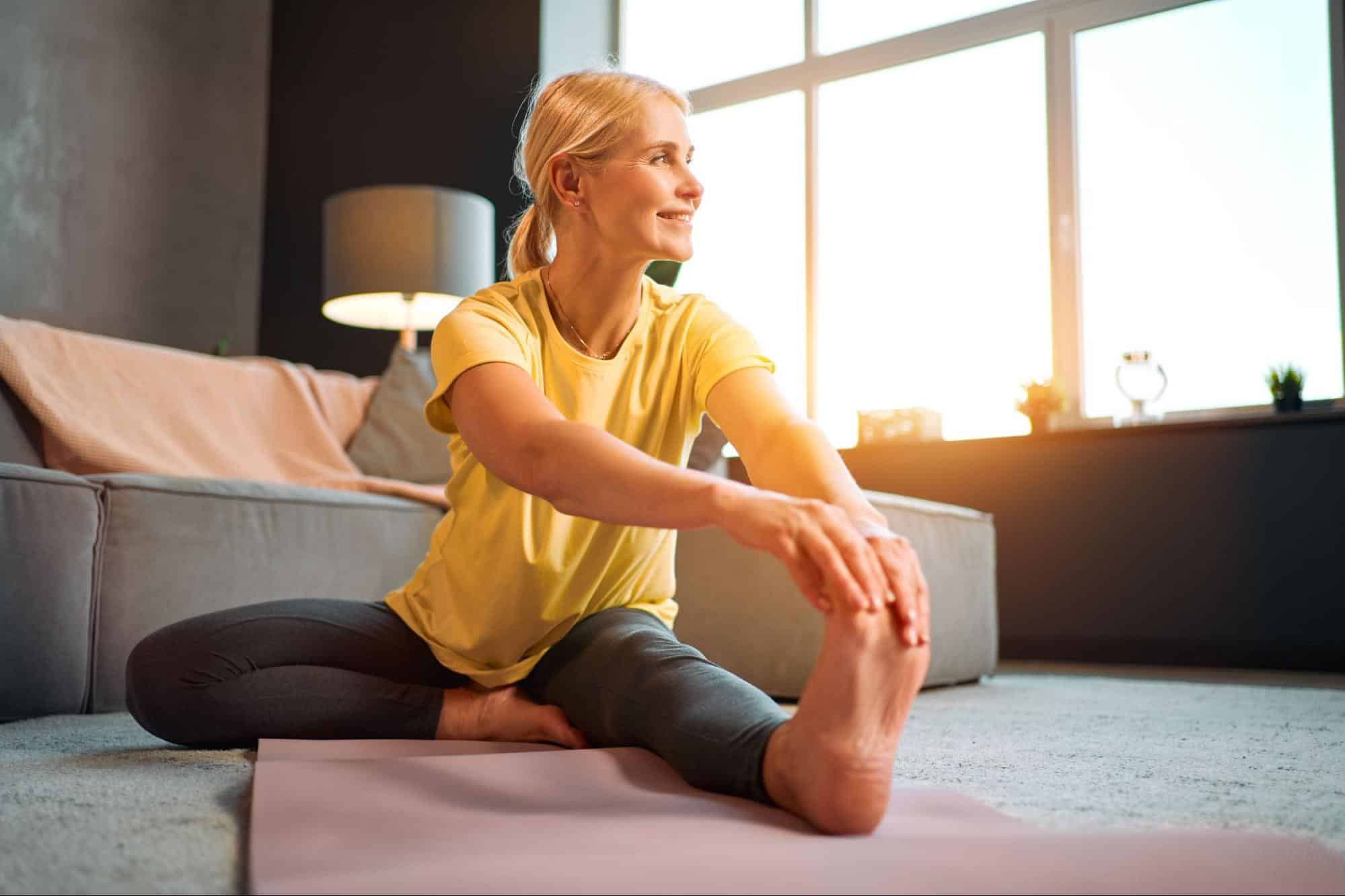 A woman stretching her left leg.