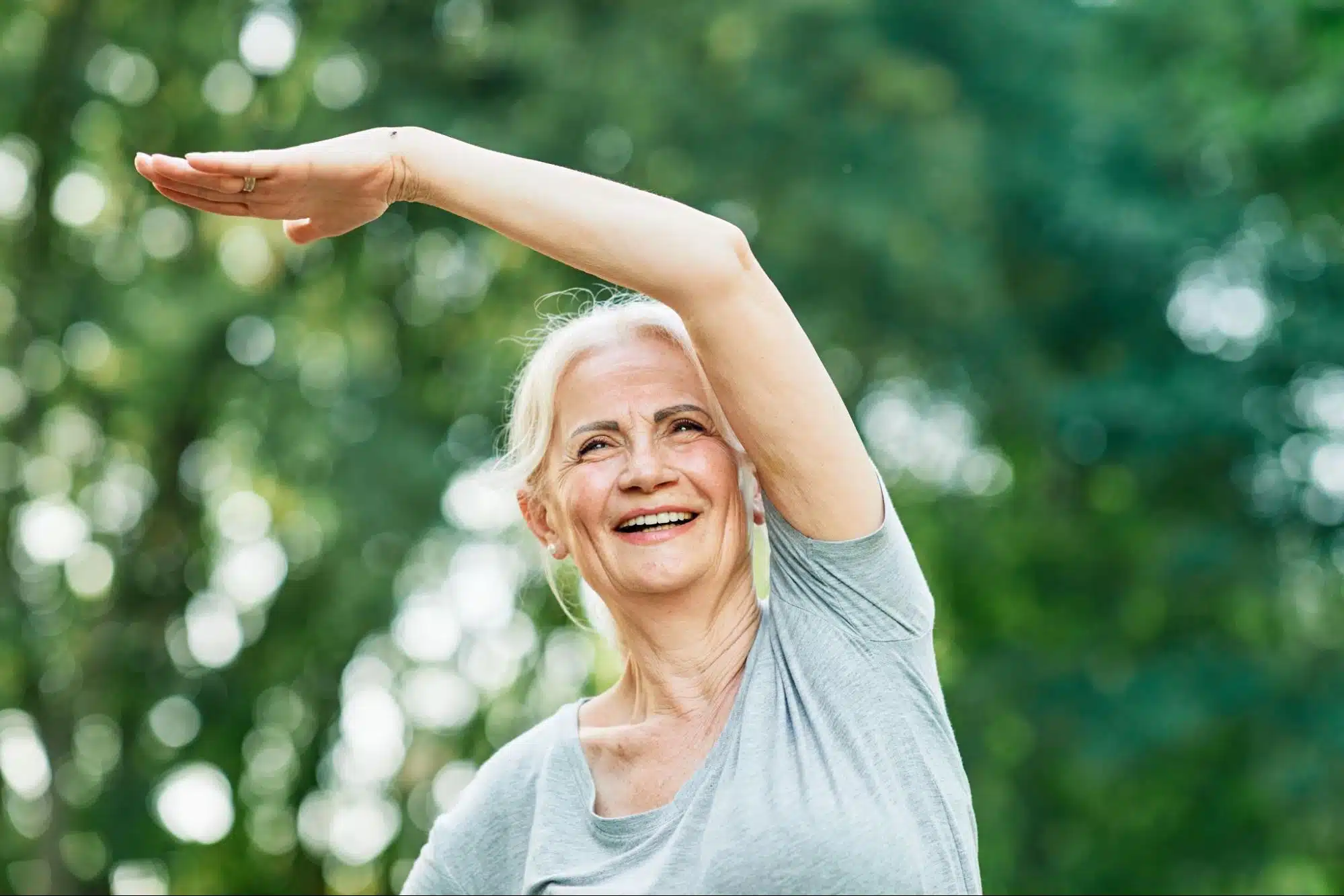 a woman stretching her left arm over her head.